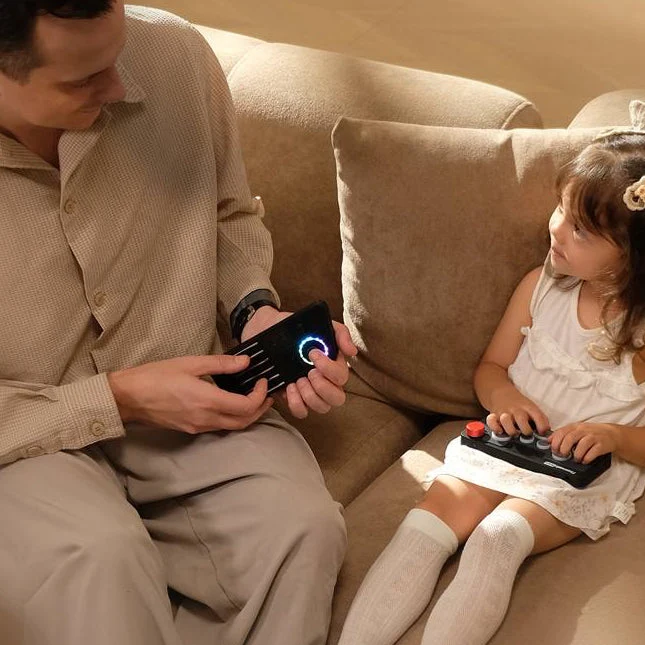 A father and daughter playing Fingersonic instruments